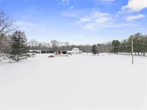 a view of yard covered with snow in the background