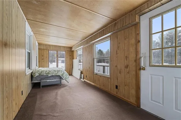 a view of a dining room with furniture and a chandelier