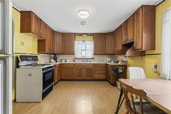 a kitchen with stainless steel appliances granite countertop a stove and a refrigerator