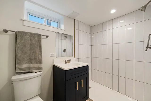 a bathroom with a sink toilet and shower