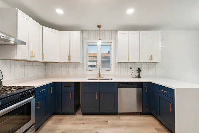 a kitchen with a sink stove and cabinets