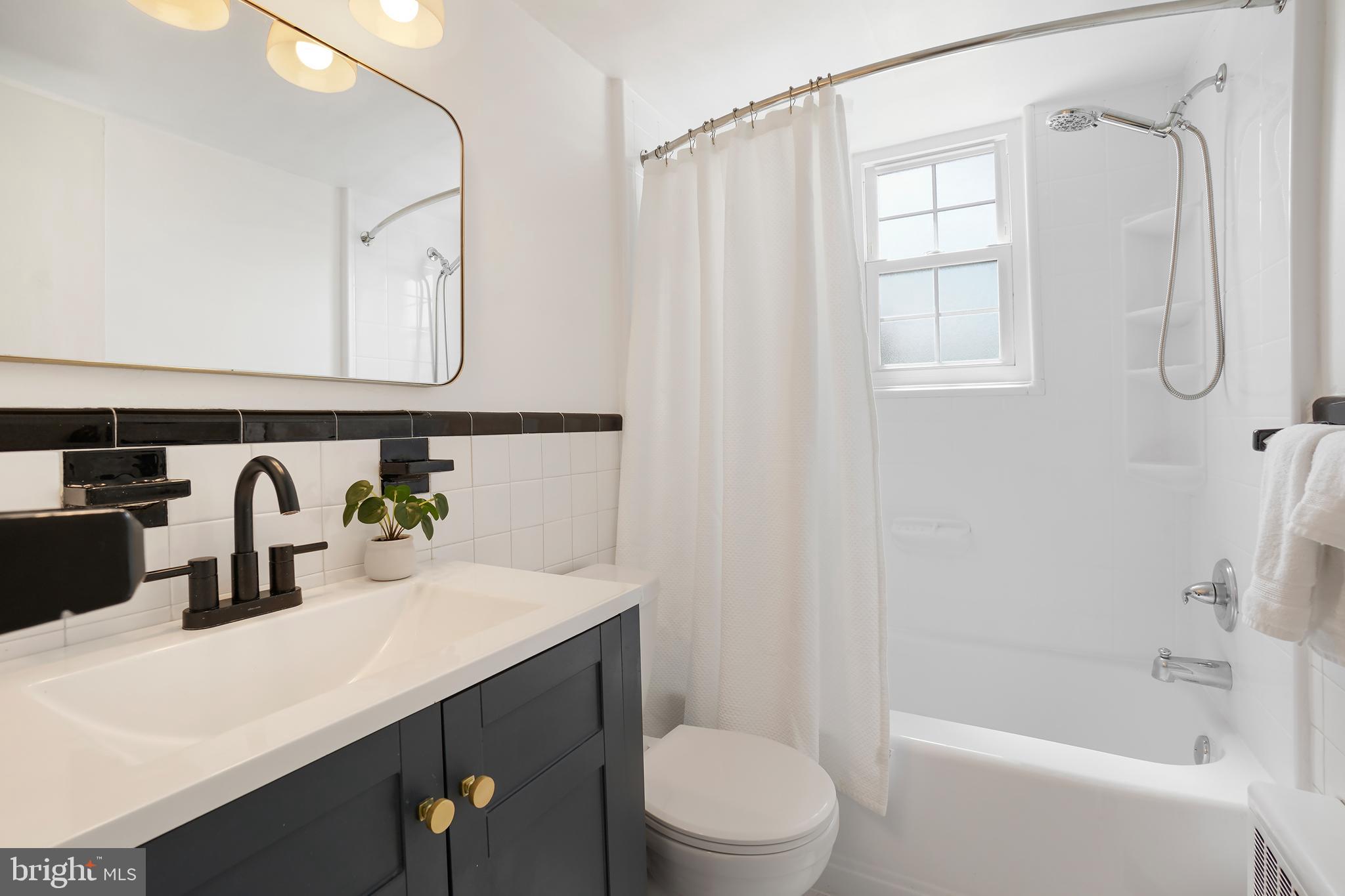 2030 North Vermont Street, Unit 301 Arlington, VA 22207 - Photo 16 of 32 a bathroom with a sink a toilet and shower