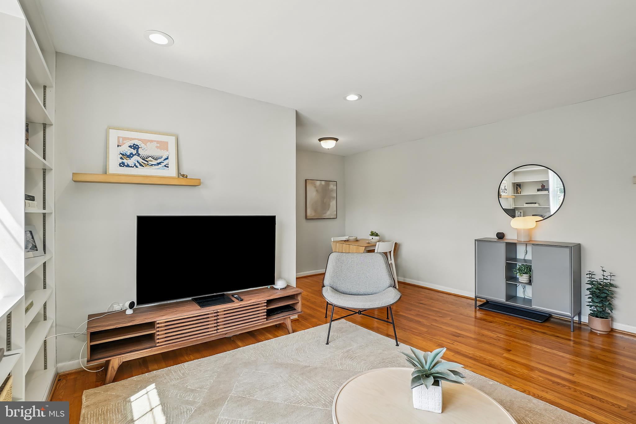 2030 North Vermont Street, Unit 301 Arlington, VA 22207 - Photo 4 of 32 a living room with furniture and a flat screen tv