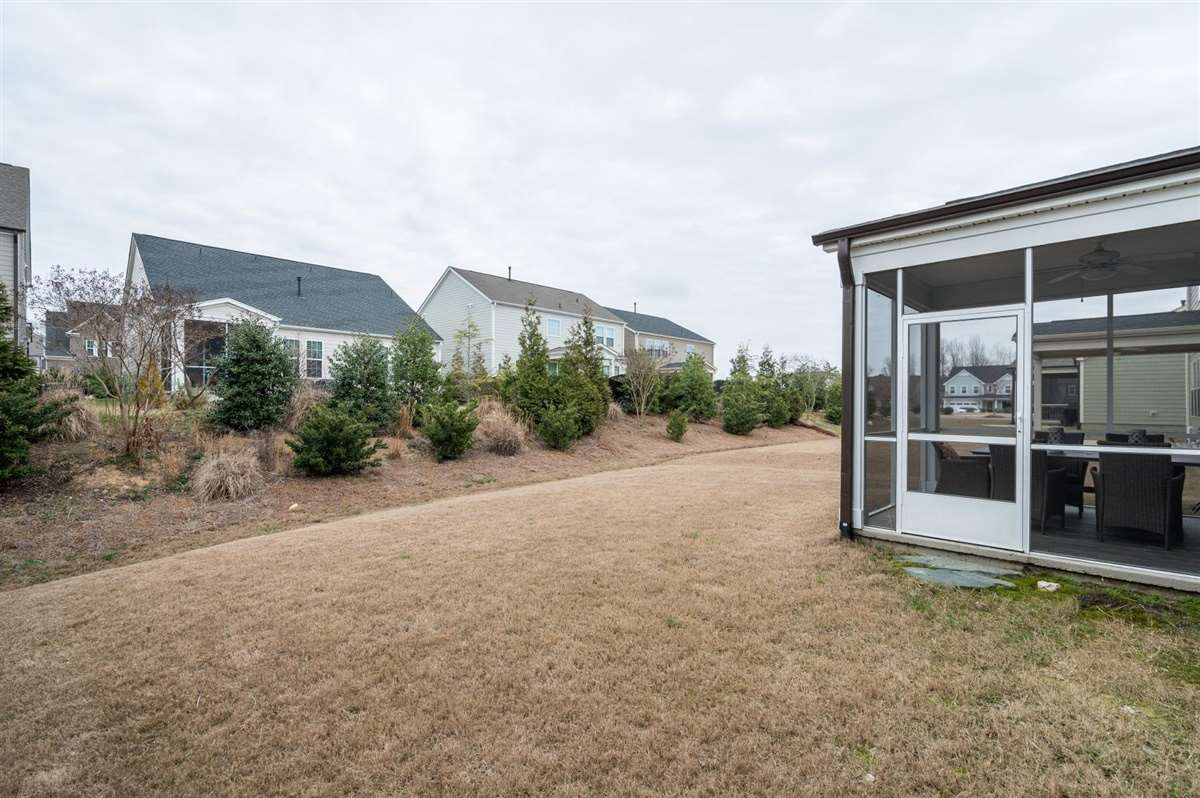 409 Morgan Ridge Road Holly Springs, NC 27540 - Photo 29 of 30 Screened porch opens to backyard! And don't forget, you're just three doors down from the neighborhood playground, clubhouse, and pool Backyard