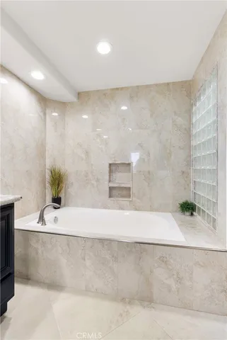 a bathroom with a double vanity sink and mirror with shower
