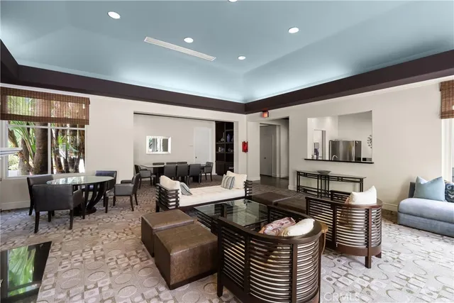 a living room with fireplace furniture and a large window