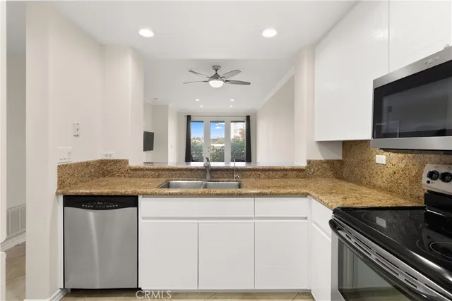 a kitchen with a sink stove and microwave