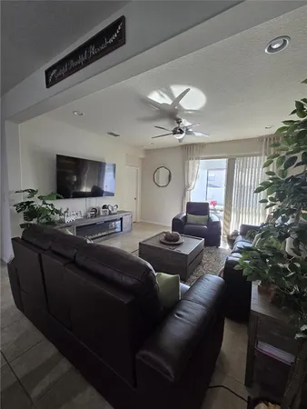 a bedroom with a bed and a flat tv screen on the dresser