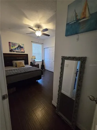 a bed sitting in a bedroom and dresser