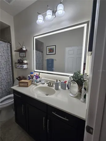 a en suite bathroom with a sink and a mirror