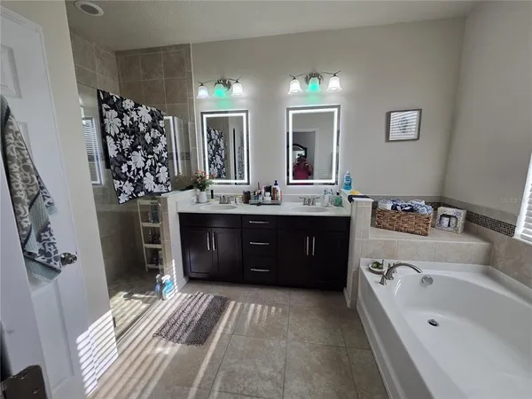 an aerial view of a house with a yard and trees