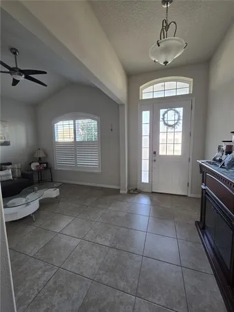 a kitchen with stainless steel appliances granite countertop a table chairs refrigerator and microwave