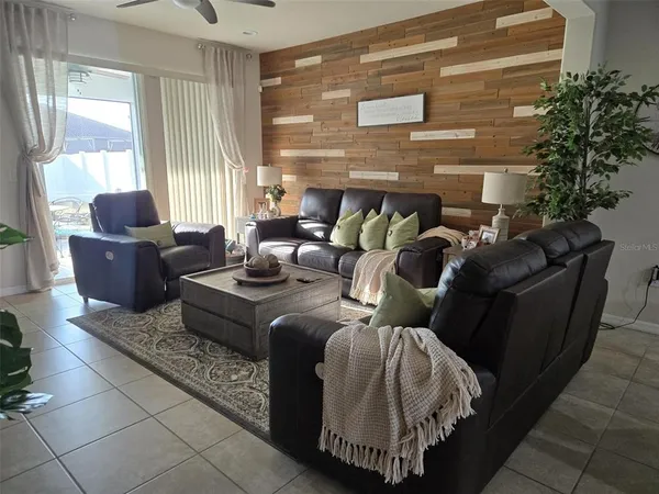 a kitchen with stainless steel appliances kitchen island granite countertop a table chairs and a refrigerator