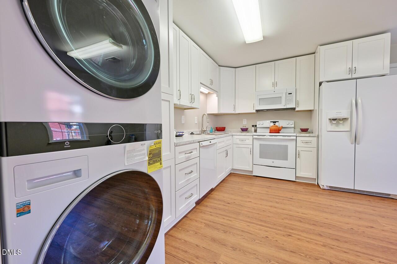 621 Martin Street Durham, NC 27704 - Photo 15 of 39 a kitchen with kitchen island granite countertop a white cabinets a sink and a stove