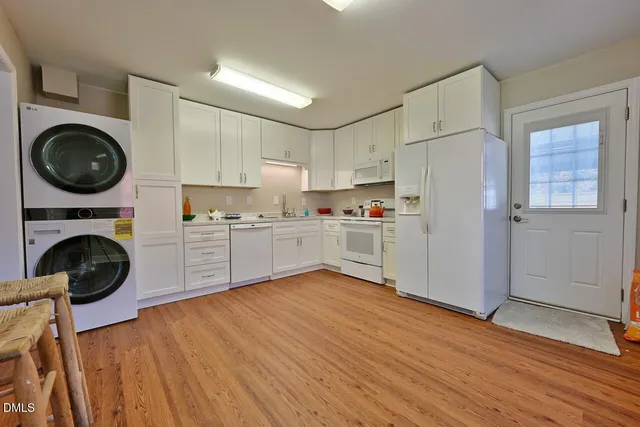 a view of a kitchen with wooden floor and electronic appliances