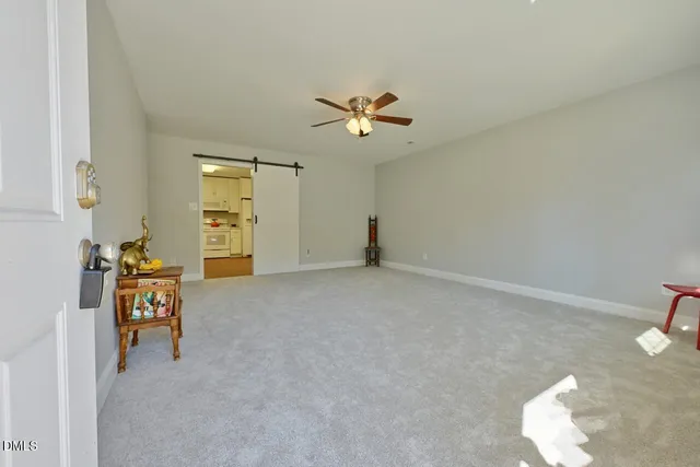 a view of a livingroom with a furniture and chandelier fan