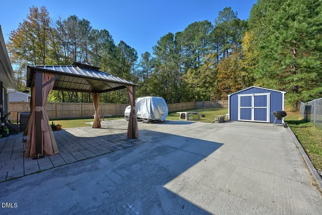 a view of a house with wooden deck and a backyard