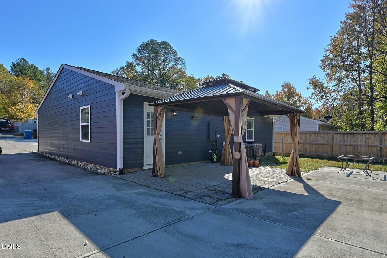 621 Martin Street Durham, NC 27704 - Photo 33 of 39 a view of a house with wooden deck and a backyard