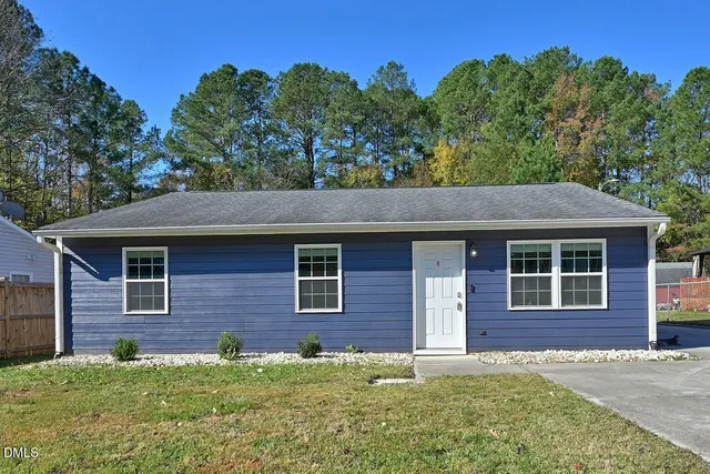 a front view of a house with yard
