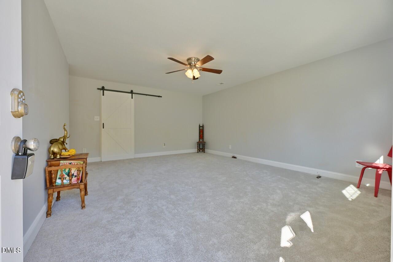 621 Martin Street Durham, NC 27704 - Photo 7 of 39 a view of a livingroom with a chair & a ceiling fan