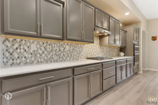 a sink with white cabinets