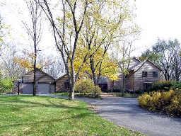 1851 Sunset Ridge Road Northbrook, IL 60062 - Photo 1 of 1 a small house with tall trees in the background