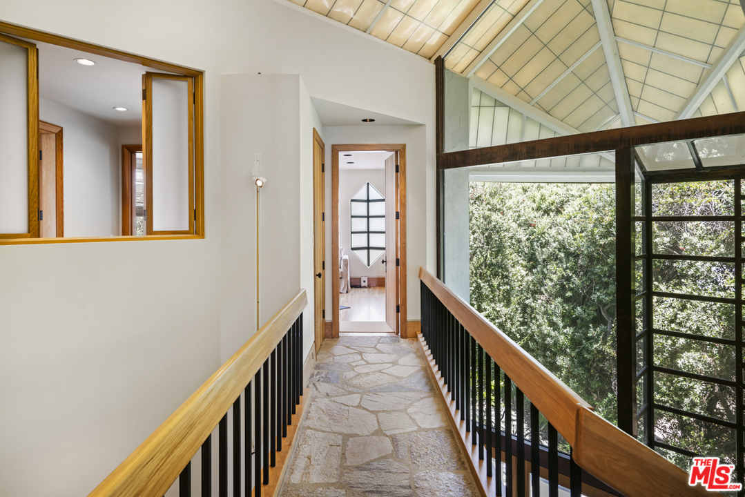 31030 Broad Beach Road Malibu, CA 90265 - Photo 16 of 45 a view of a hallway with wooden floor and staircase