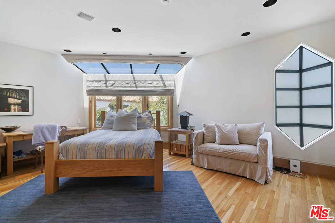 31030 Broad Beach Road Malibu, CA 90265 - Photo 22 of 45 a bedroom with furniture and a large window