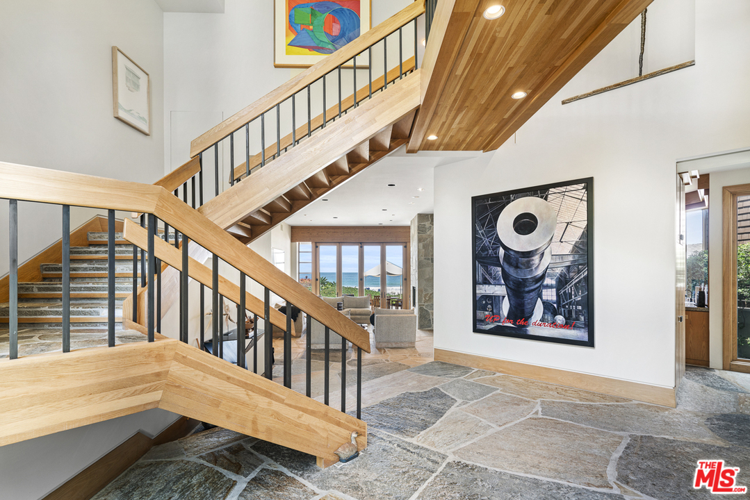 31030 Broad Beach Road Malibu, CA 90265 - Photo 4 of 45 a view of staircase with lots of frames on wall