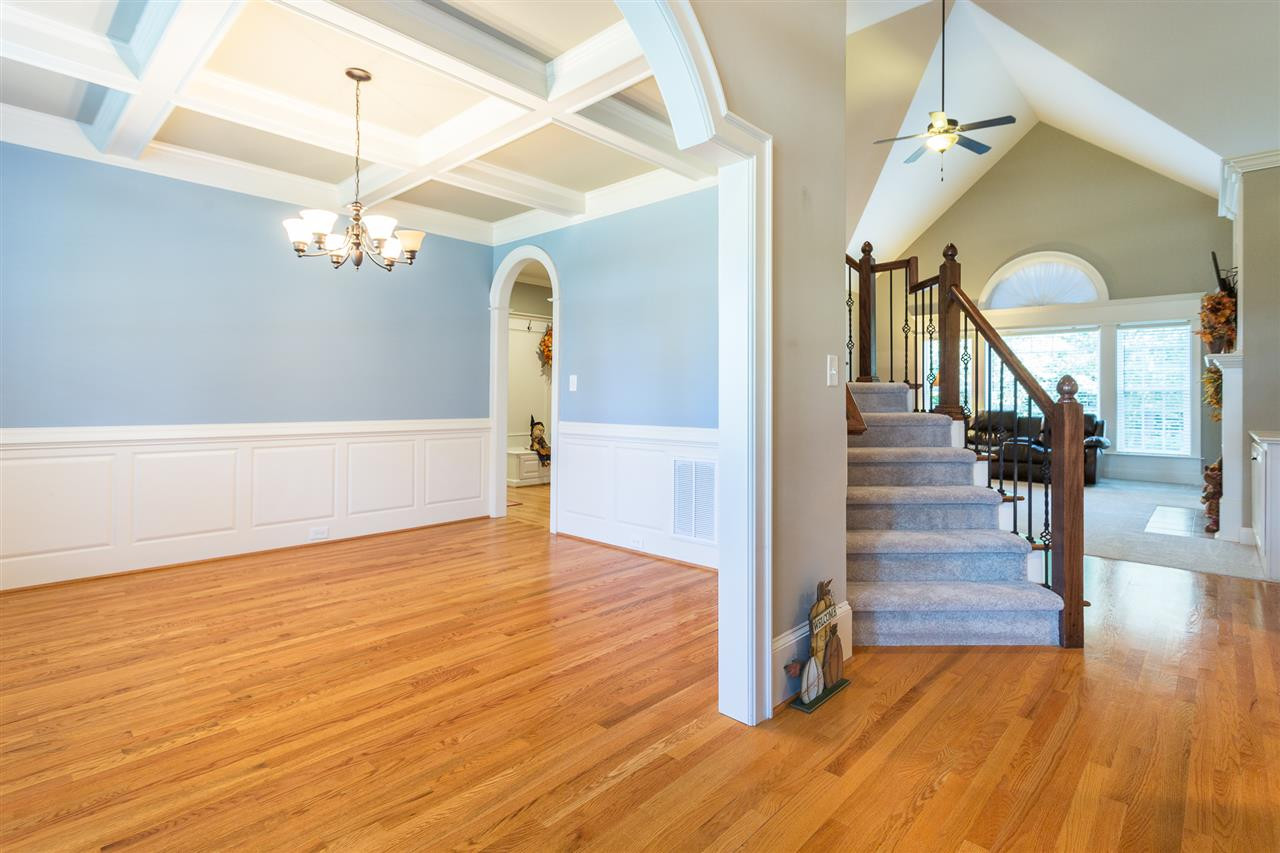 12 Vista Ridge Drive Willow Spring, NC 27592 - Photo 5 of 30 A beautiful view from the entry foyer of the formal dining room. This elegant dining room features an arched entry way with heavy trim, a coffered ceiling with an oil rubbed bronze light fixture, chair railing, wainscoting, and beautiful hardwood floors. Formal Dining Room