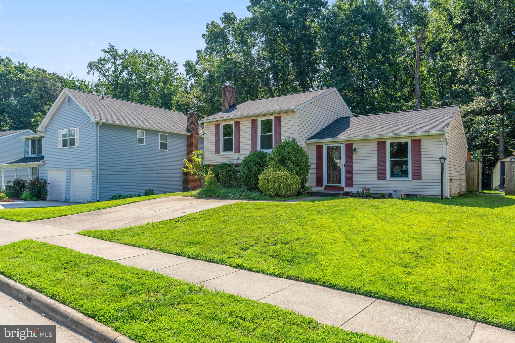 7627 Fallswood Way Lorton, VA 22079 - Photo 1 of 38 a front view of a house with garden
