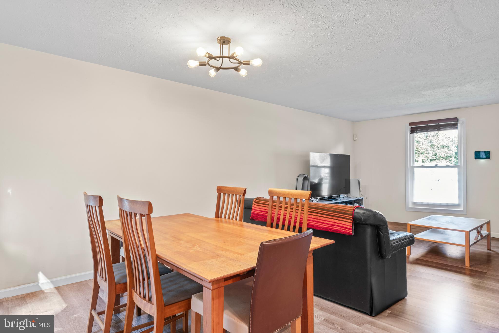 7627 Fallswood Way Lorton, VA 22079 - Photo 10 of 38 a view of a dining room with furniture and wooden floor
