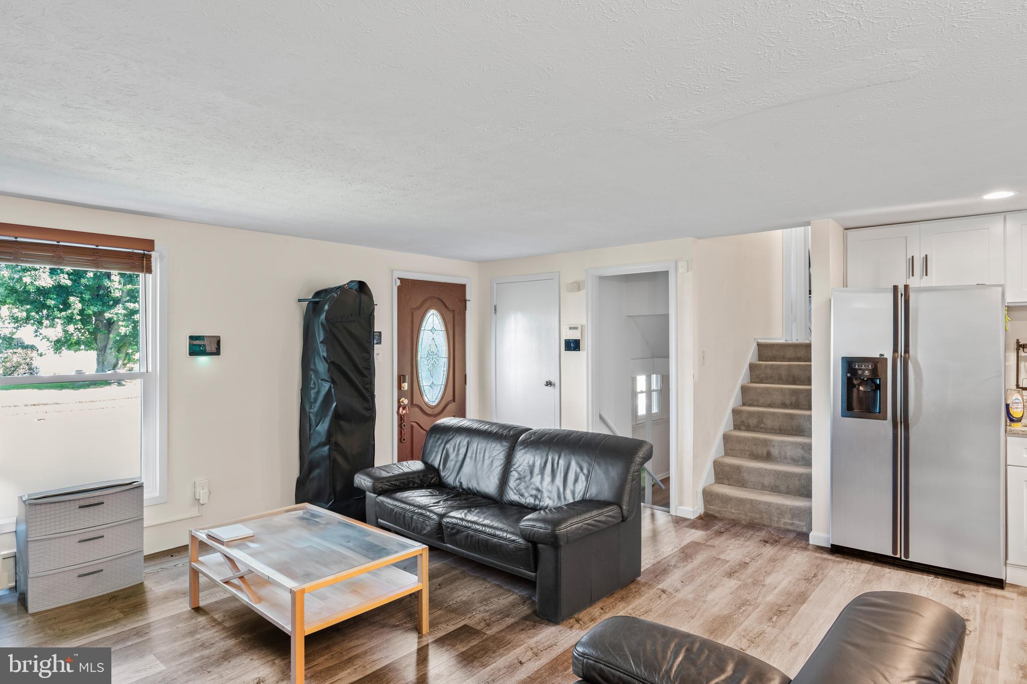 7627 Fallswood Way Lorton, VA 22079 - Photo 11 of 38 a living room with furniture and a wooden floor