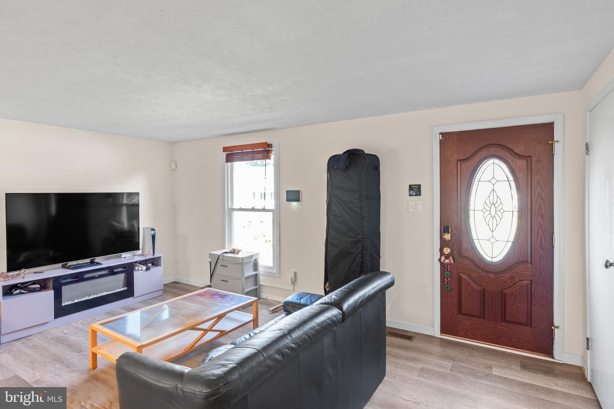 7627 Fallswood Way Lorton, VA 22079 - Photo 12 of 38 a living room with furniture and a flat screen tv