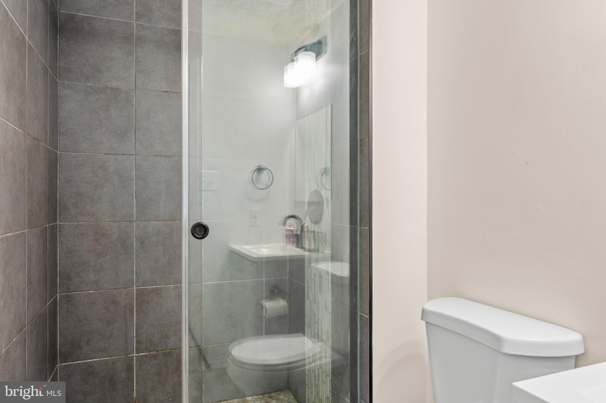 7627 Fallswood Way Lorton, VA 22079 - Photo 17 of 38 a bathroom with a toilet and a shower