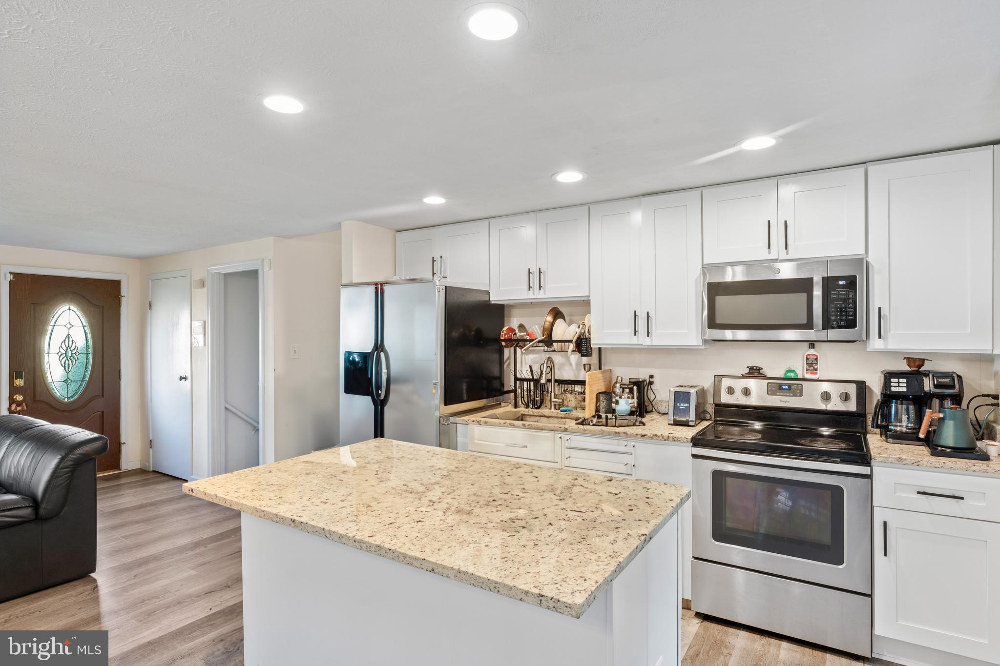7627 Fallswood Way Lorton, VA 22079 - Photo 2 of 38 a kitchen with stainless steel appliances granite countertop a sink stove and refrigerator