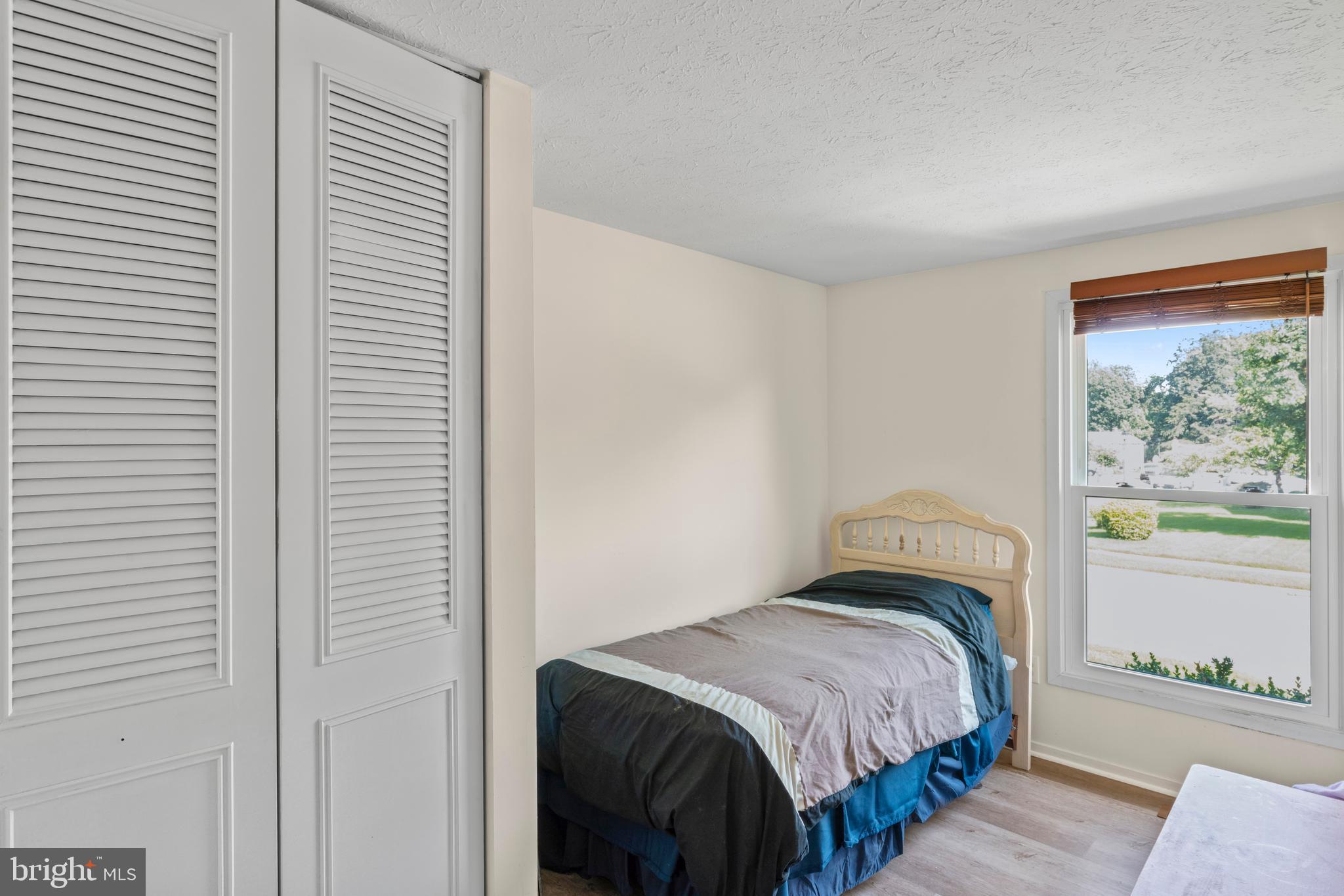 7627 Fallswood Way Lorton, VA 22079 - Photo 22 of 38 a bedroom with a bed and a window