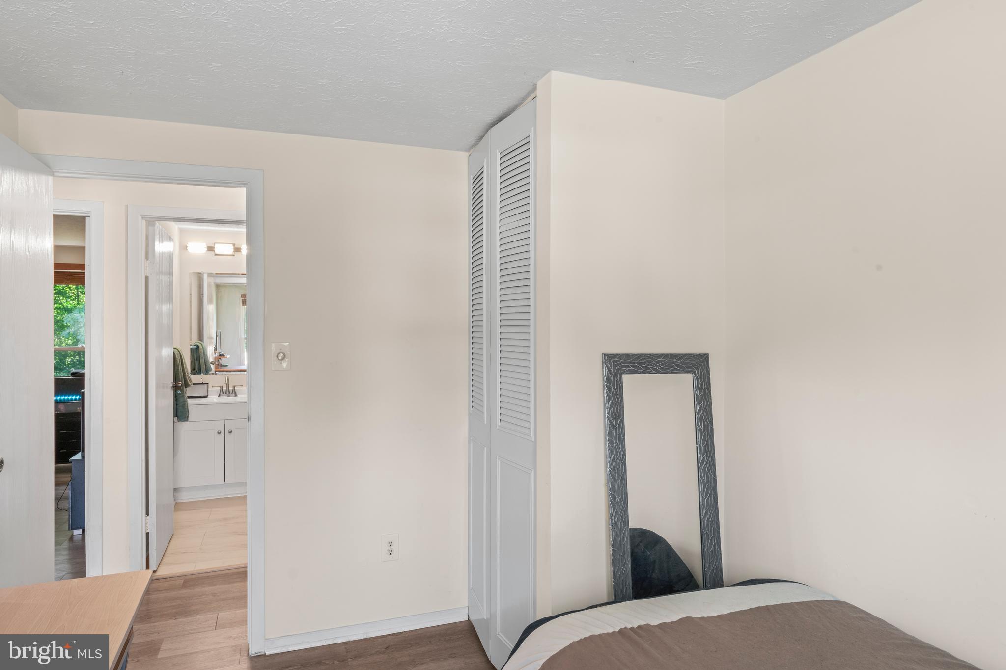 7627 Fallswood Way Lorton, VA 22079 - Photo 23 of 38 a bedroom with a bed and a mirror