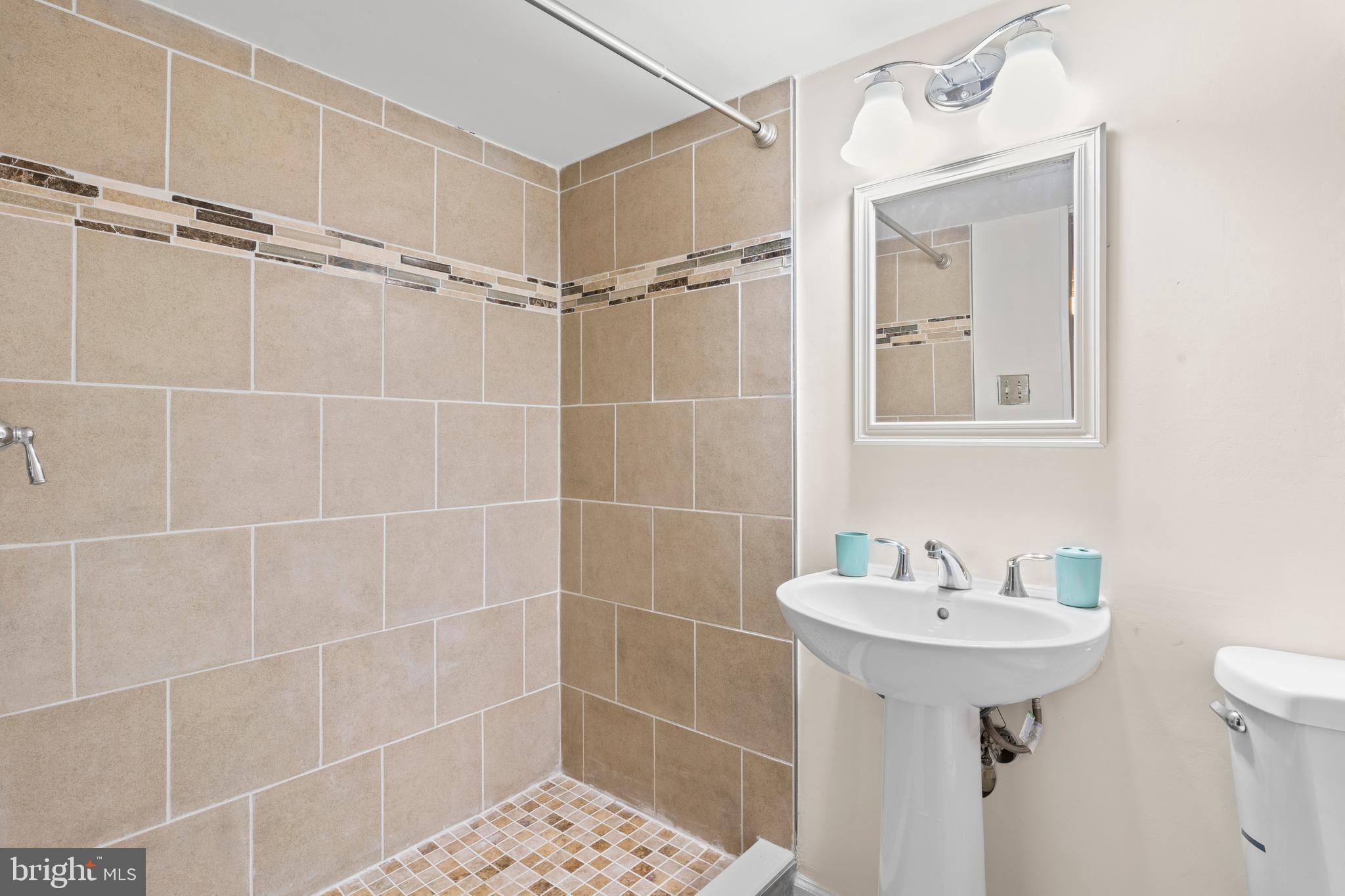 7627 Fallswood Way Lorton, VA 22079 - Photo 29 of 38 a bathroom with a sink toilet and shower