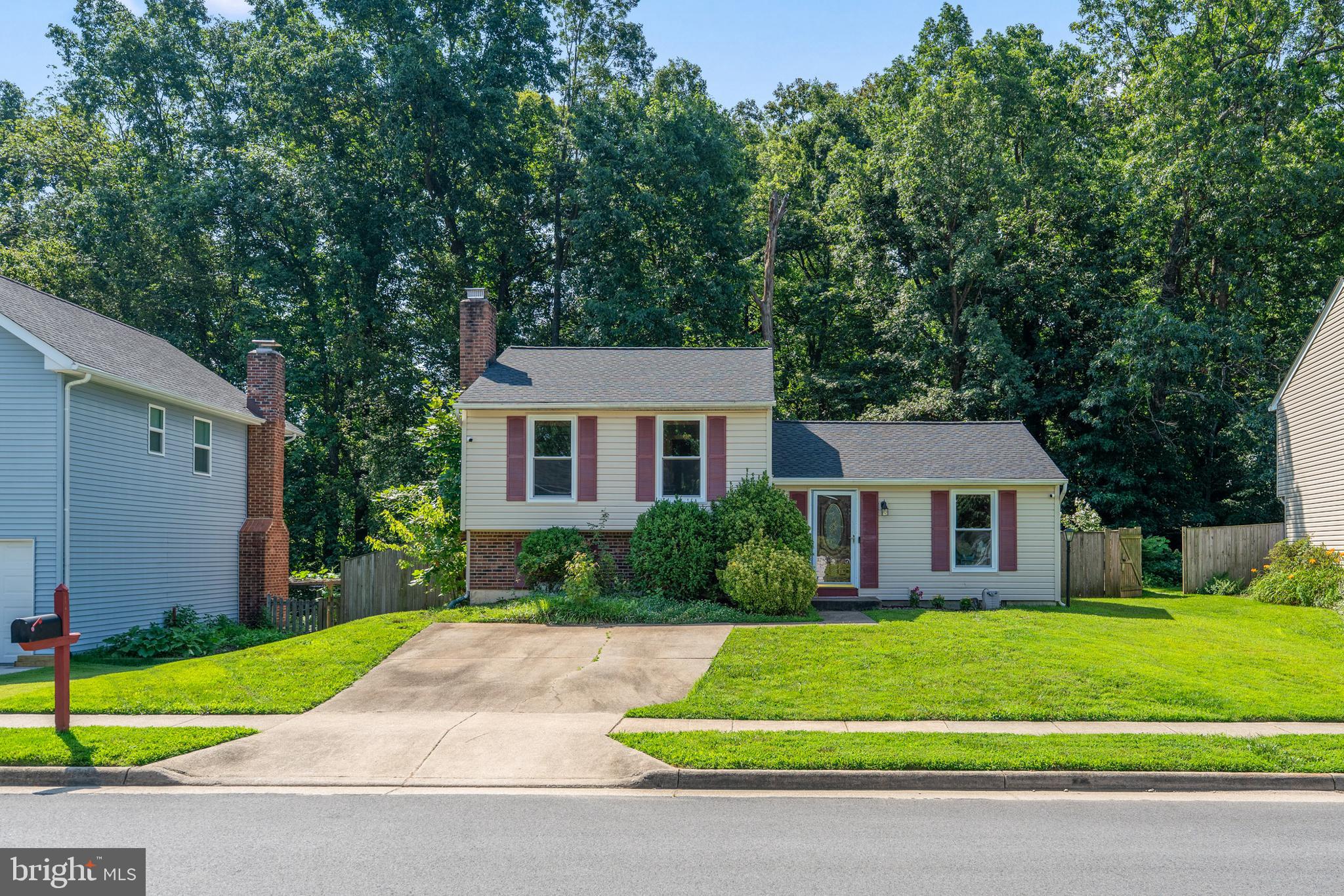 7627 Fallswood Way Lorton, VA 22079 - Photo 31 of 38 a front view of a house with a yard and trees