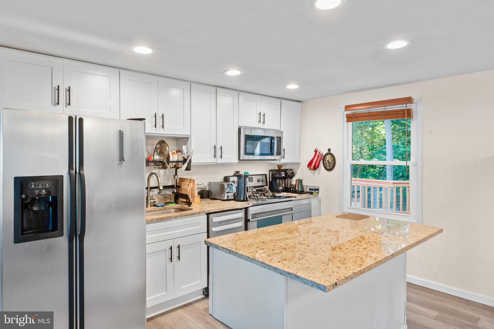 7627 Fallswood Way Lorton, VA 22079 - Photo 5 of 38 a kitchen with stainless steel appliances granite countertop refrigerator sink and microwave