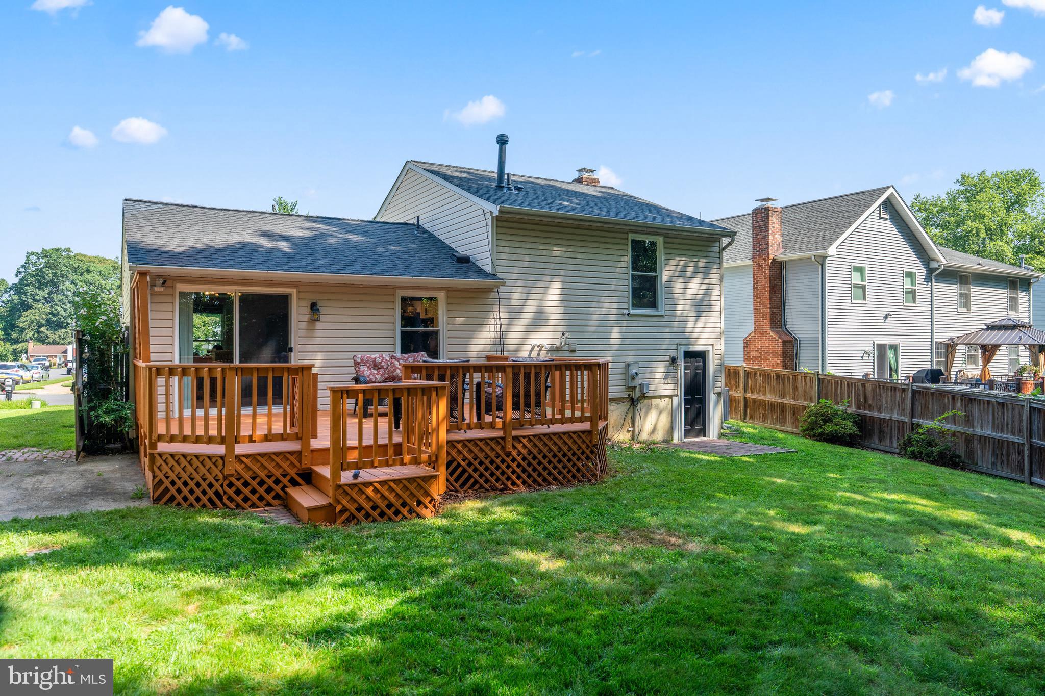 7627 Fallswood Way Lorton, VA 22079 - Photo 7 of 38 a view of a house with a backyard and a patio