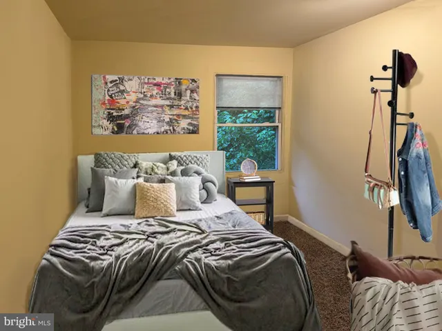 a bed sitting in a bedroom next to a window