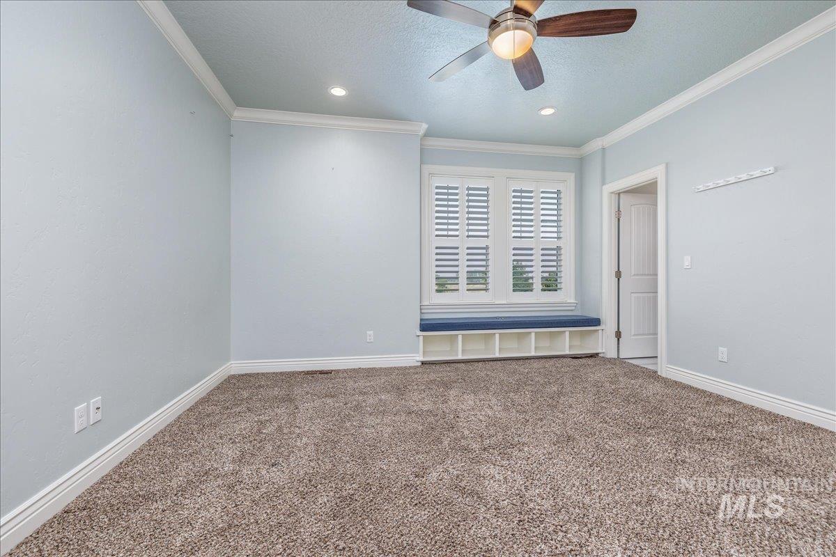 5744 North Star Ridge Way Star, ID 83669 - Photo 24 of 50 Carpeted room featuring elegant wainscoting and crown molding