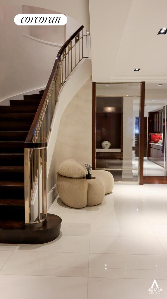 46 East 66th Street Manhattan, NY 10065 - Photo 6 of 64 a view of staircase with a flat screen tv and couches