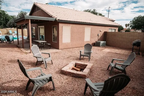 a view of a patio with table and chairs with wooden floor and fence