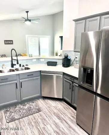 a kitchen with a refrigerator sink and cabinets