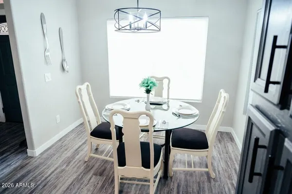 a view of a dining room with furniture and wooden floor