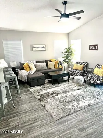 a living room with furniture and a wooden floor