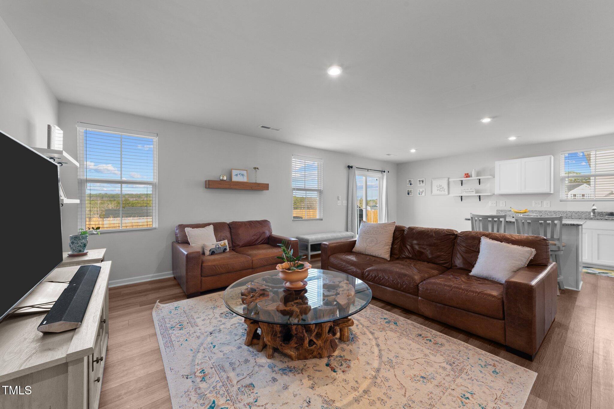 45 Florentine Court Angier, NC 27501 - Photo 14 of 27 a living room with furniture a rug and a flat screen tv